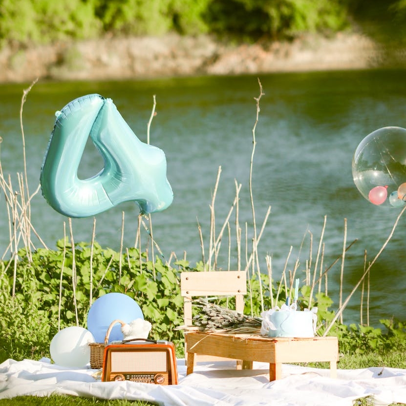 outdoor birthday picnic with decorations by river